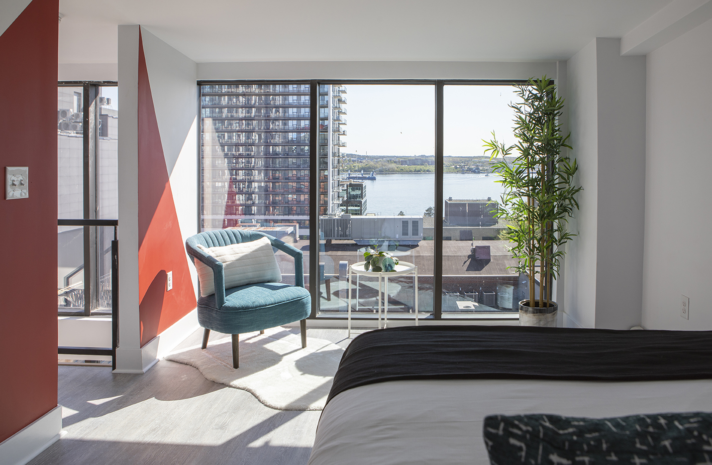 A sunlit Cameo Suites guest room overlooking the Halifax waterfront